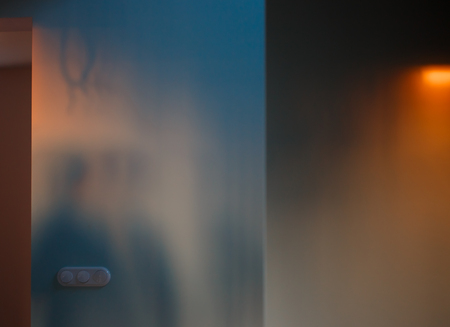 Empty wall of the room lit by orange sunset light. Abstract backgroundの写真素材