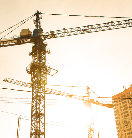 Building site with high-rise block under construction in an urban environment dominated by a large...