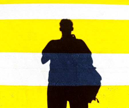 Silhouette of a man on crosswalk.の写真素材