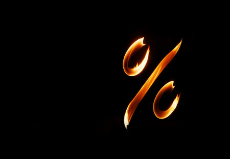 percent sign on a black background with fireの素材