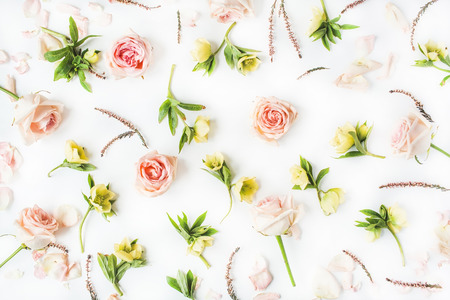 Wallpaper, texture. Pink roses and yellow flowers on white background. Flat lay, top viewの写真素材