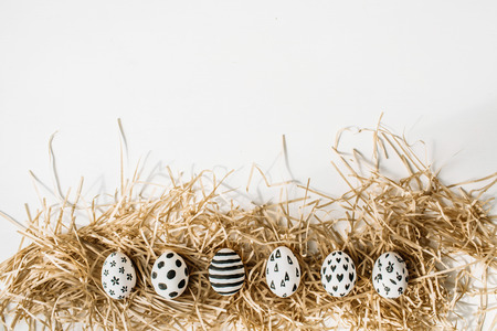 Easter eggs painted in monochrome style isolated on white. Flat lay. Drops, flowers, hearts, stars, stripesの写真素材