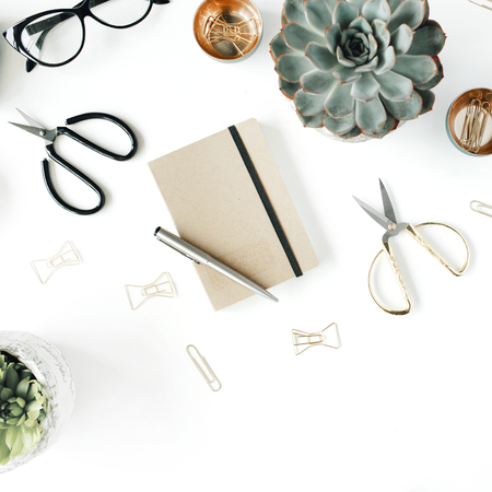 feminini desk workspace with succulent, scissors, diary, glasses and golden clips on white background. flat lay, top viewの写真素材