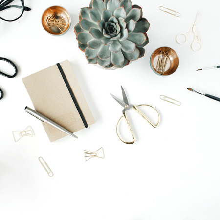 feminini desk workspace with succulent, scissors, diary, glasses and golden clips on white background. flat lay, top viewの写真素材