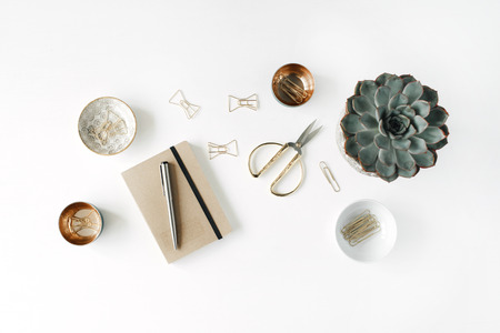 feminini desk workspace with succulent, scissors, diary and golden clips on white background. flat lay, top viewの写真素材