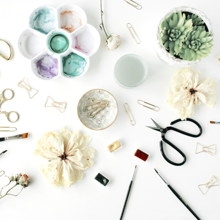 flat lay composition with bow tie clips, scissors, dry tulip, roses, palette, succulent on white background. top viewの写真素材