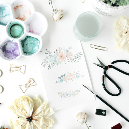 flat lay floral watercolor painting with bow tie clips, scissors, dry tulip, roses, palette, succulent on white background. top viewの写真素材