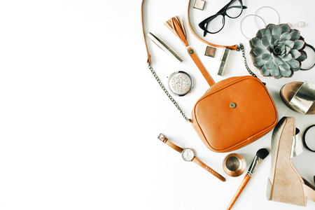 flat lay feminine accessories collage with purse, watch, glasses, bracelet, lipstick, sandals, mascara, brushes on white background.の写真素材