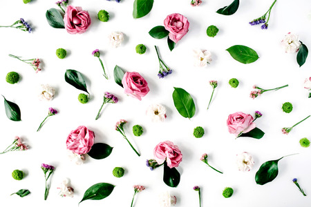 Wallpaper, texture. Pink roses and white flowers on white background. Flat lay, top viewの写真素材