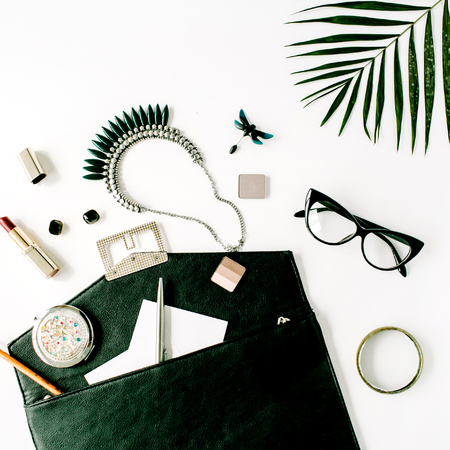 beauty feminine accessories arrangement with palm branch, purse, glasses, lipstick and necklace. flat lay, top viewの写真素材