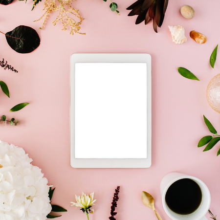 creative decorated and arranged flat lay frame concept with tablet, vintage tray, hydrangea, shells, coffee, golden spoon, branches on pink background. top viewの写真素材