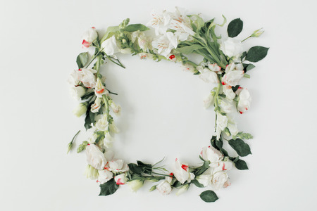 round frame wreath pattern with roses, pink flower buds, branches and leaves isolated on white background. flat lay, top viewの写真素材