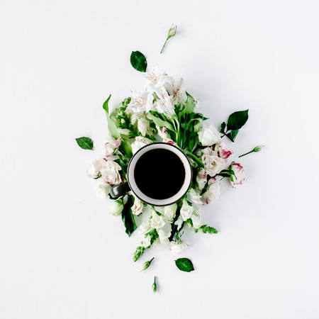 Colorful bright image made of leaves, roses and petals with coffee cup on white. flat lay, top viewの写真素材