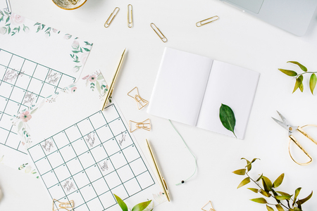 wedding planner schedule calendar painted with watercolor, laptop, notebook and accessories. flat lay workspace, top viewの写真素材