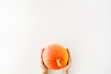 pumpkin in girl's hands. flat lay autumn wallpaperの写真素材
