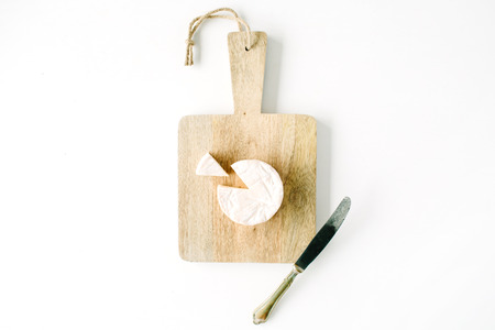 camembert cheese and knife on cutting board. flat lay, top viewの写真素材