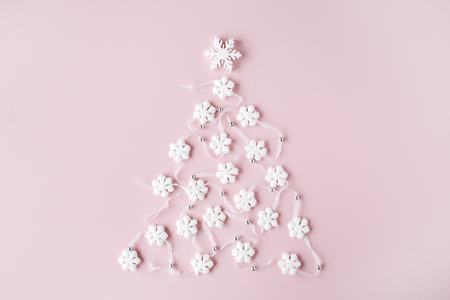 white christmas tree decoration on pink background. christmas wallpaper. flat lay, top viewの写真素材