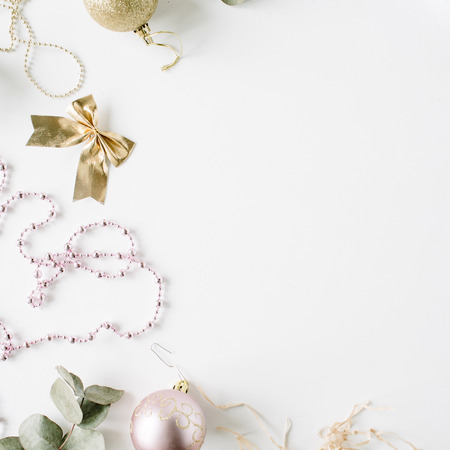 frame made of christmas decoration with christmas glass balls, tinsel, bow, eucalyptus. christmas wallpaper. flat lay, top viewの写真素材