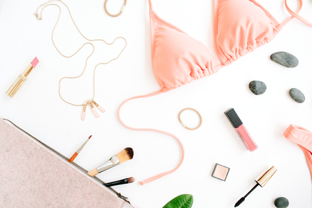 female summer bikini swimsuit and accessories collage on white with palm branches, necklace and lipstick. flat lay, top viewの写真素材