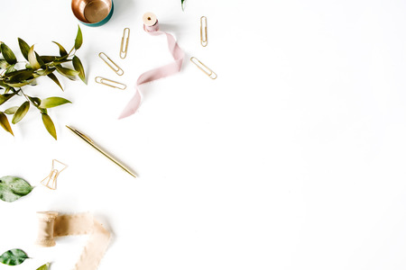 feminine home office workspace mockup with branches, golden pen, clips and beige ribbon. flat lay, top viewの写真素材