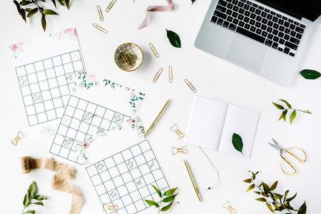 wedding planner schedule calendar painted with watercolor, laptop, notebook and accessories. flat lay workspace, top viewの写真素材