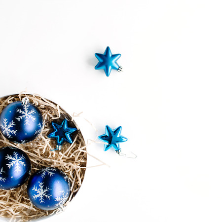 round box with bright blue christmas balls on white background. flat lay, top viewの写真素材