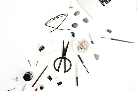 Flat lay, top view office table desk. Workspace with laptop, scissors, glasses, pen on white background.の写真素材
