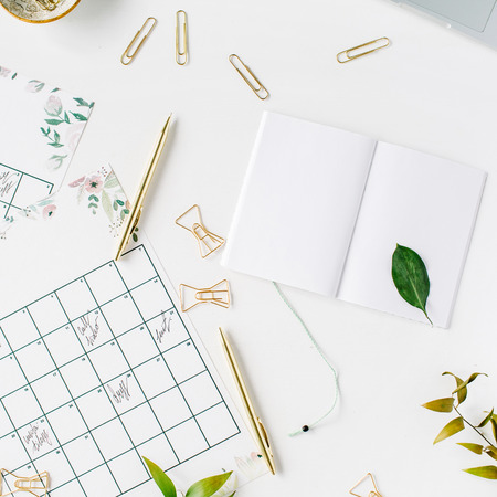 wedding planner schedule calendar painted with watercolor, laptop, notebook and accessories. flat lay workspace, top viewの写真素材