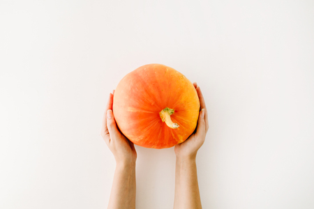 pumpkin in girl's hands. flat lay autumn wallpaperの写真素材