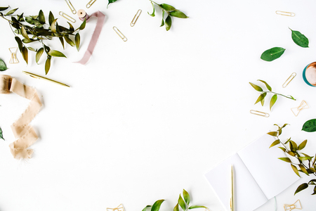 feminine home office workspace mockup with branches, golden pen, clips and beige ribbon. flat lay, top viewの写真素材