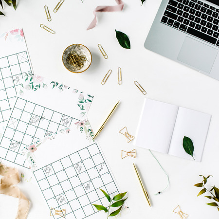 wedding planner schedule calendar painted with watercolor, laptop, notebook and accessories. flat lay workspace, top viewの写真素材