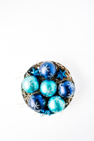round box with bright blue christmas balls on white background. flat lay, top viewの写真素材