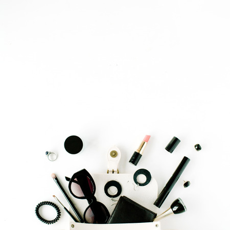 flat lay feminine arrangement with wallet, accessories, purse, cosmetics, sunglasses on white, flat lay, top viewの写真素材