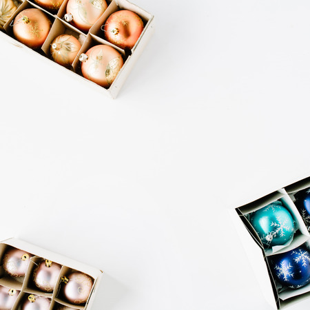 box with bright christmas balls on white background. flat lay, top viewの写真素材