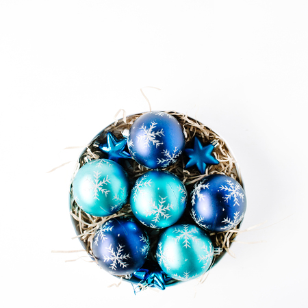 round box with bright blue christmas balls on white background. flat lay, top viewの写真素材