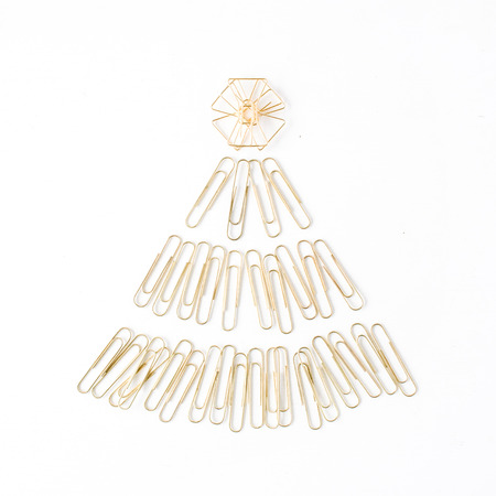 creative arrangement of bright golden christmas tree made of clips on white background. flat lay, top viewの写真素材