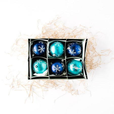 box with bright blue christmas balls on white background. flat lay, top viewの写真素材