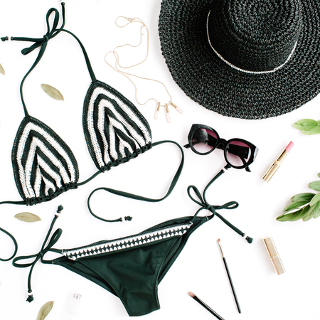 female summer bikini swimsuit accessories collage on white with hat, green branches, necklace and sunglasses. flat lay, top viewの写真素材