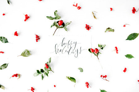 words happy holidays and minimal creative berry arrangement pattern on white. flat lay, top view. christmas background wallpaper.の写真素材