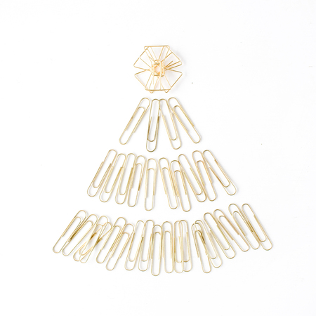creative arrangement of bright golden christmas tree made of clips on white background. flat lay, top viewの写真素材