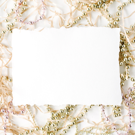 empty paper blank and christmas tinsel decoration. flat lay, top viewの写真素材