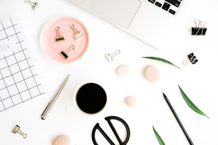 Flat lay, top view office table desk. Workspace with notebook, laptop, palm branch, coffee cup, scissors and clips on white background.の写真素材