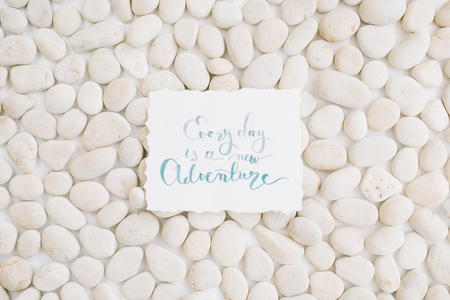 Inspirational quote on neutral pattern of beige stones. Flat lay, top viewの写真素材