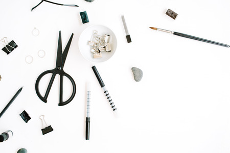 Flat lay, top view office table desk. Workspace with scissors, glasses, pen on white background.の写真素材