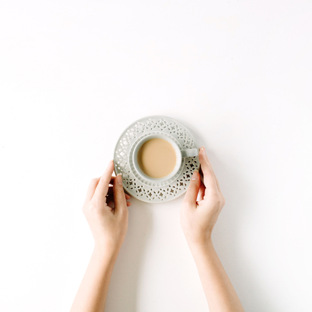 girl's hands holding coffee cup. flat lay, top viewの写真素材