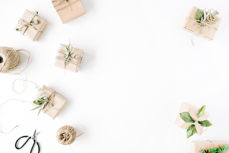 creative arrangement pattern of craft boxes and green branches on white background. flat lay, top viewの写真素材