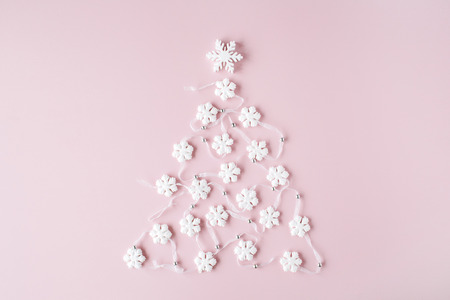 white christmas tree decoration on pink background. christmas wallpaper. flat lay, top viewの写真素材