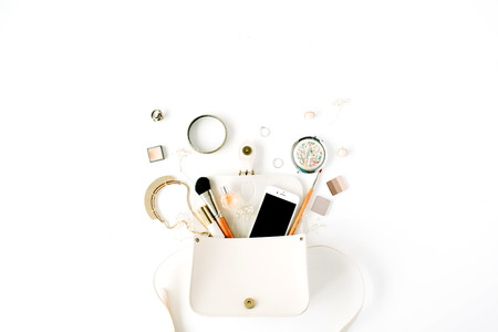 flat lay feminine arrangement with phone, accessories, purse, cosmetics on white, flat lay, top viewの写真素材