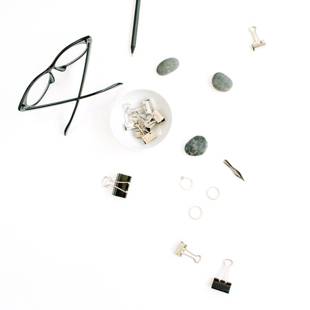 Flat lay, top view office table desk. Feminine accessories with glasses and clipsの写真素材