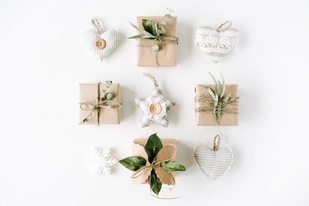 creative arrangement of handmade knitted christmas toys and craft boxes on white background. flat lay, top viewの写真素材